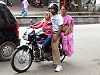 Family going to church on a motor cycle