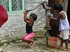 Boys pumping water